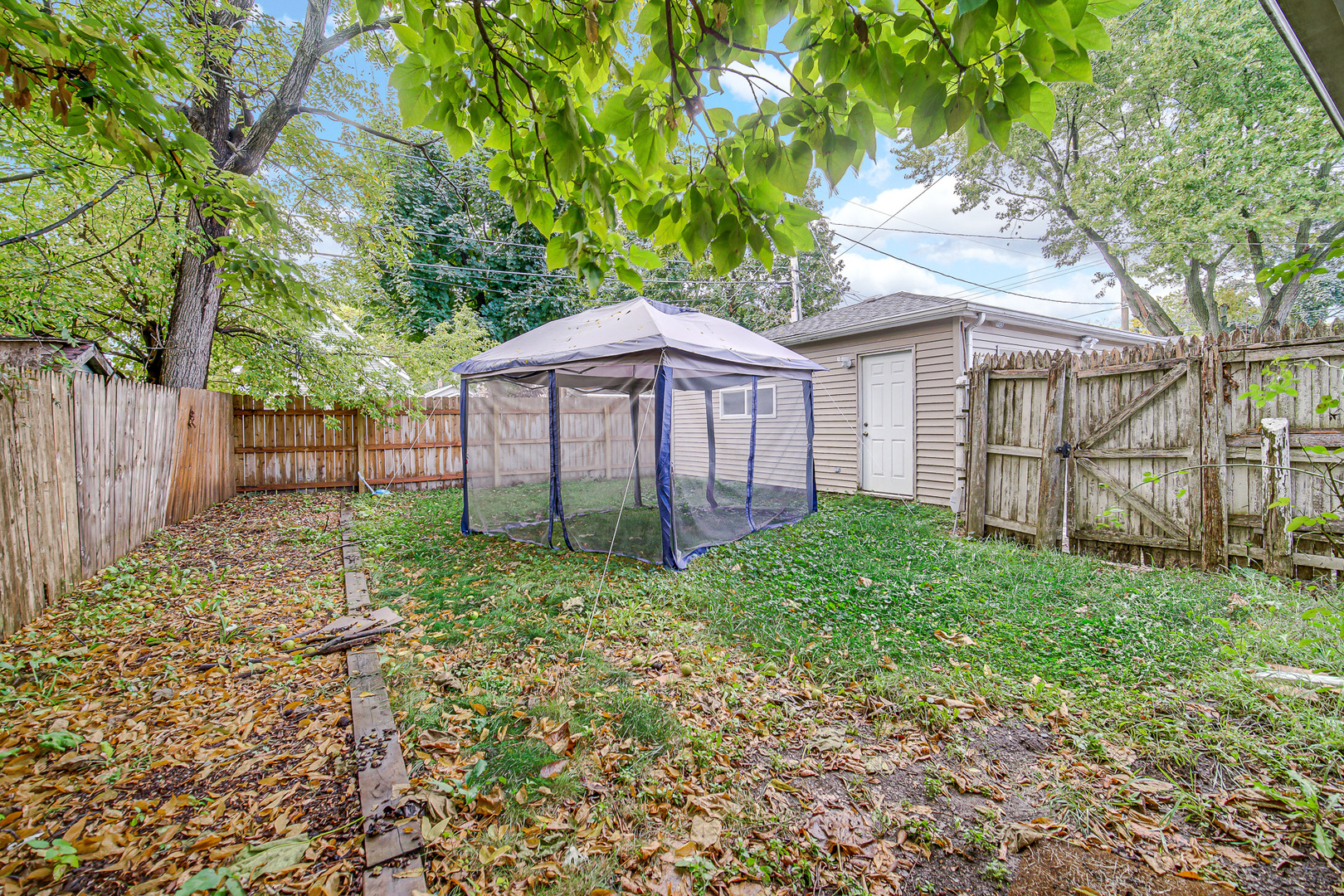 1521 Catalpa Street Waukegan, IL 60085 - Photo 20 of 22 a view of a house with a yard and plants