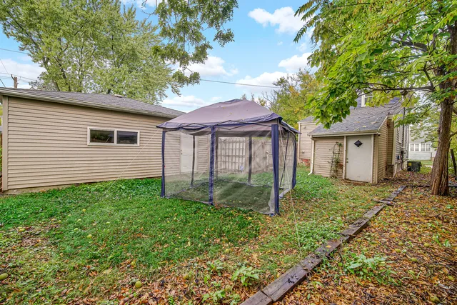 a view of a house with wooden fence