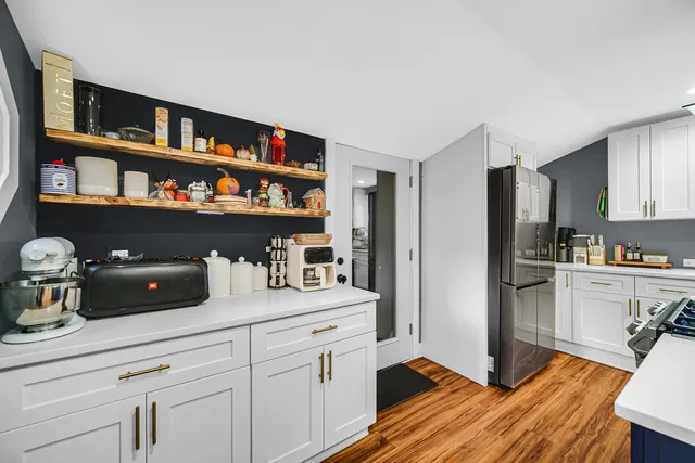 a kitchen with stainless steel appliances a refrigerator sink and cabinets