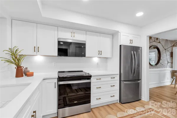 a kitchen with appliances a washer and dryer