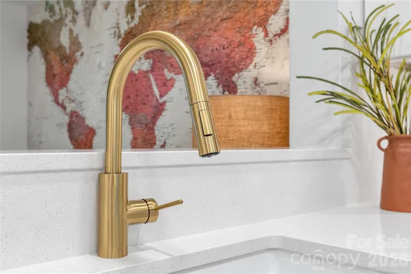 a view of entryway with paintings on the wall