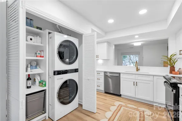 a view of a kitchen with a washer and dryer