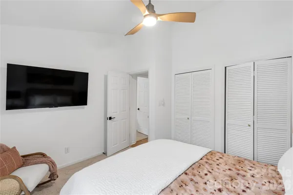 a bedroom with a bed and a television