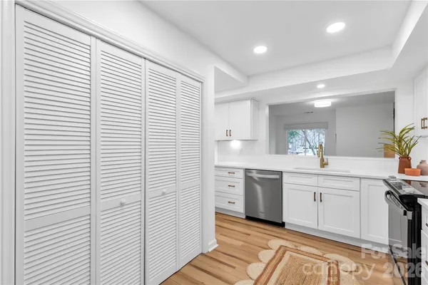 a kitchen with white cabinets and white appliances