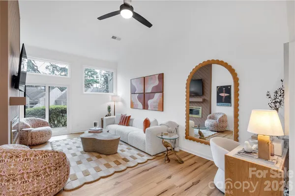 a living room with furniture chess table and a large window