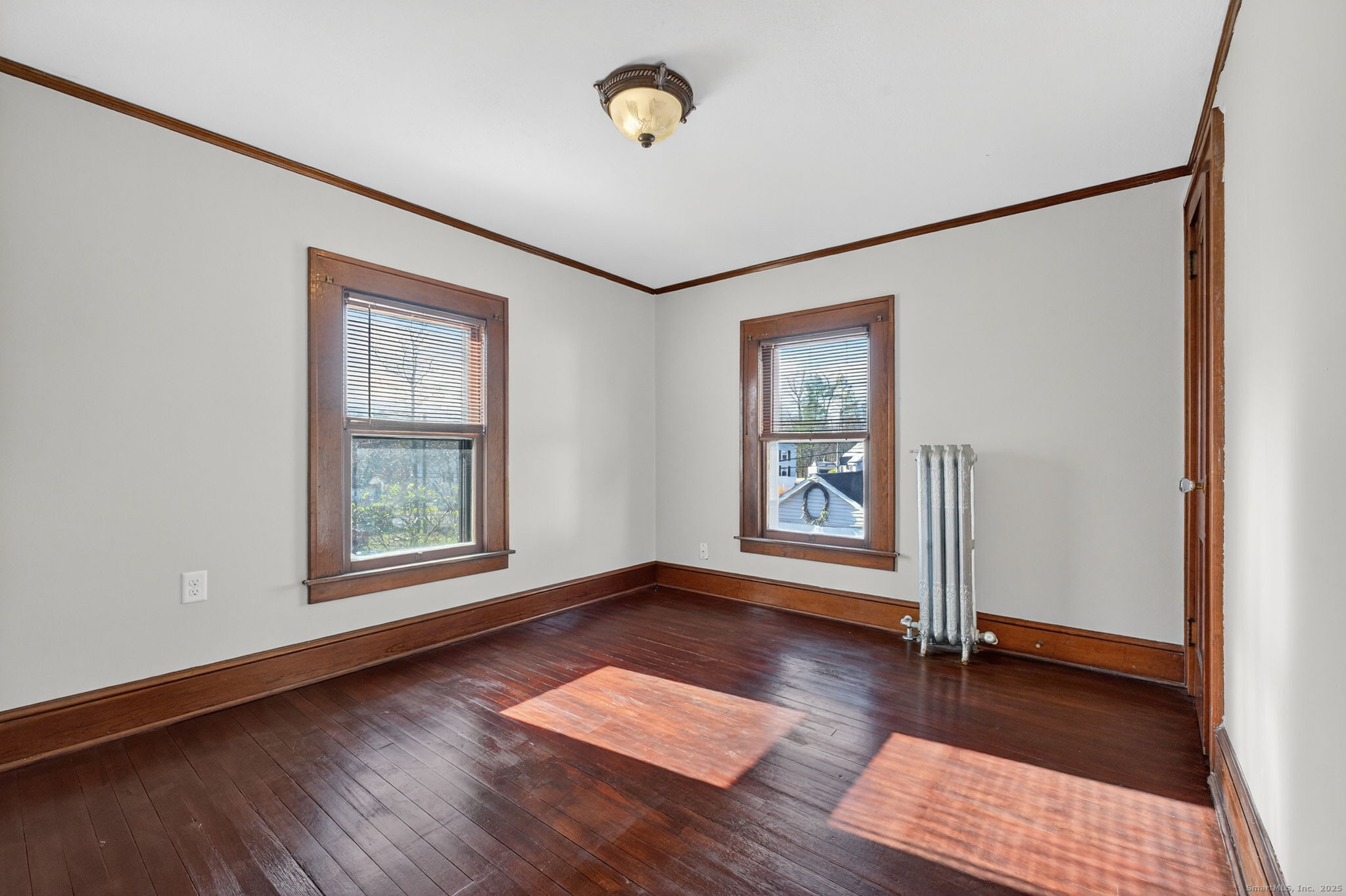 12 North Main Street Windsor Locks, CT 06096 - Photo 15 of 31 an empty room with wooden floor and windows