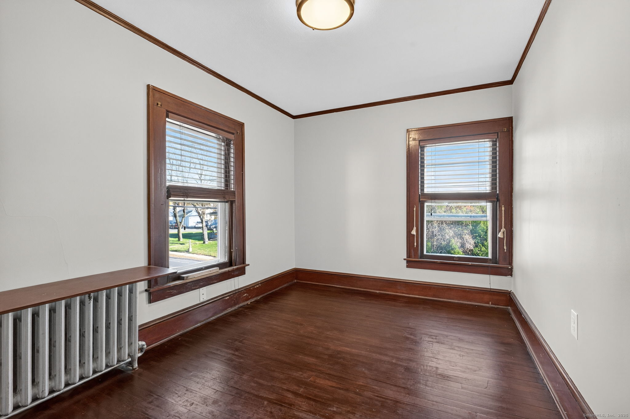 12 North Main Street Windsor Locks, CT 06096 - Photo 17 of 31 a view of an empty room with wooden floor and a window