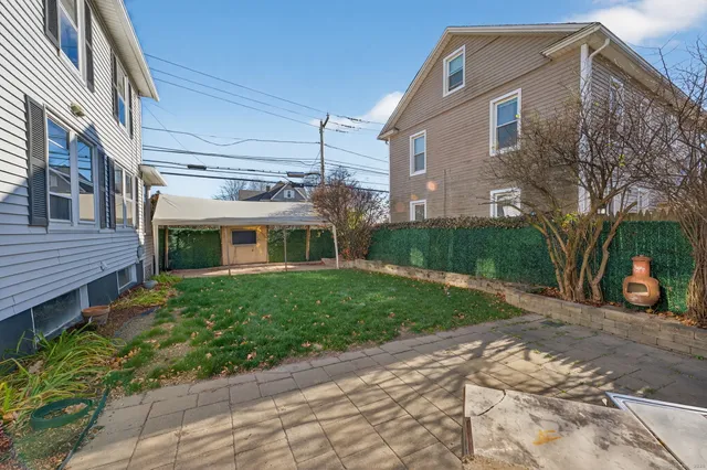 a front view of a house with a yard and a garage