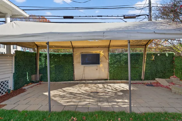 a backyard of a house with lots of green space and glass windows
