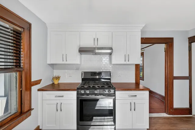 a kitchen with stainless steel appliances granite countertop a stove and a refrigerator