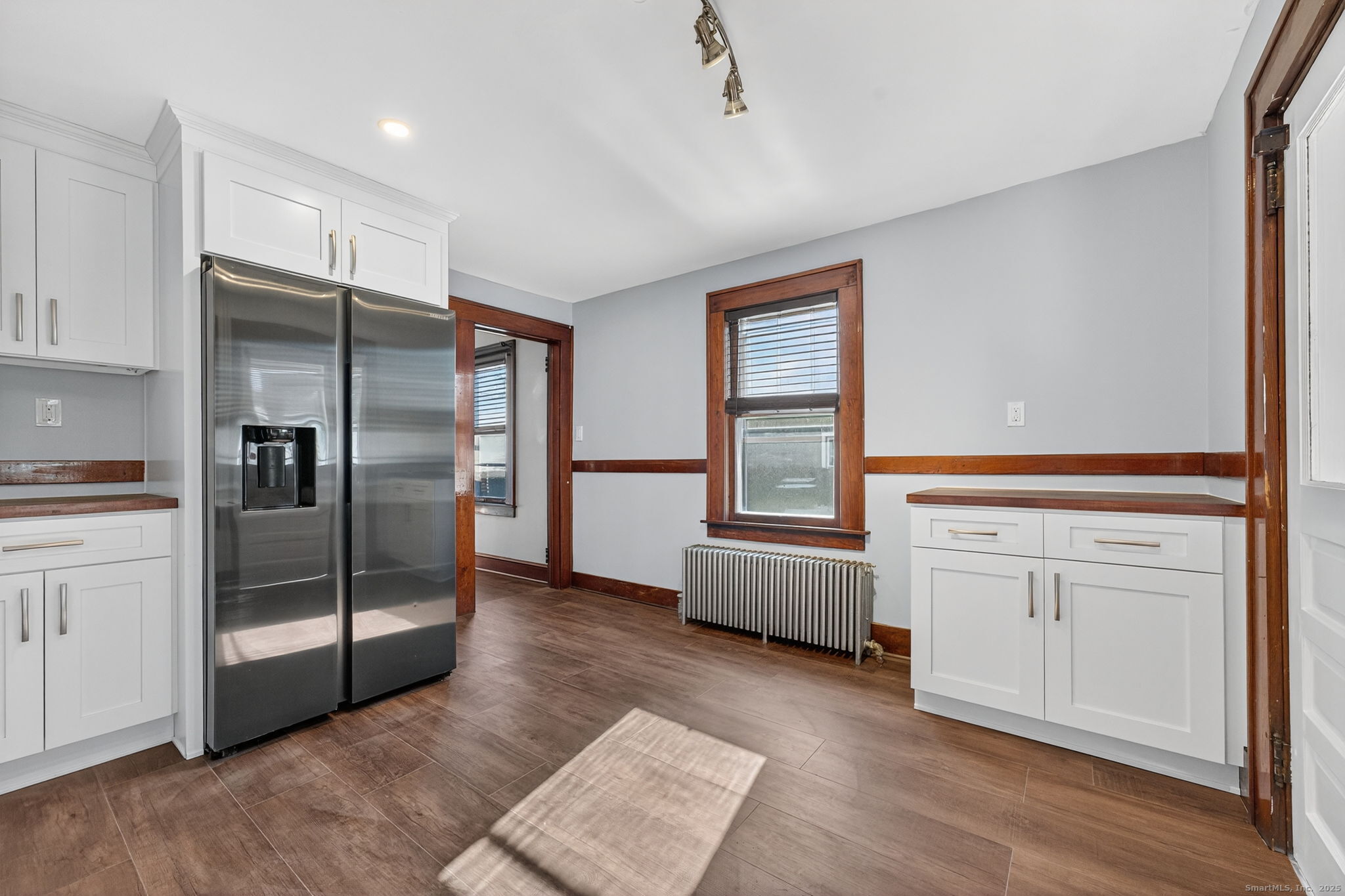 12 North Main Street Windsor Locks, CT 06096 - Photo 4 of 31 a kitchen with white cabinets and refrigerator