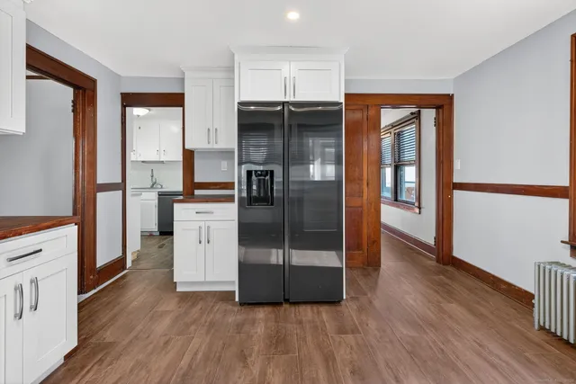 a kitchen with granite countertop a refrigerator and a stove top oven