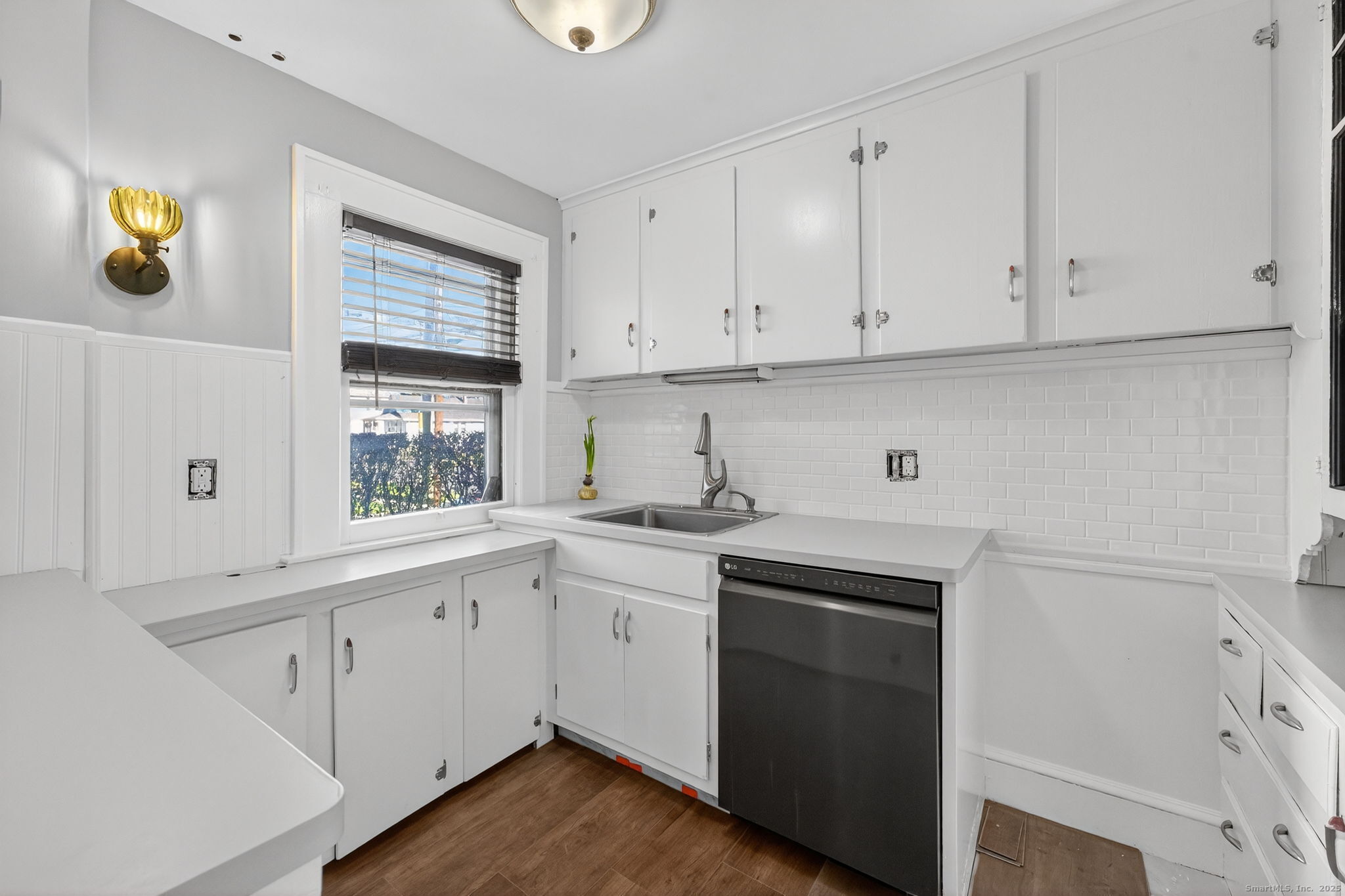 12 North Main Street Windsor Locks, CT 06096 - Photo 7 of 31 a kitchen with cabinets appliances a sink and a window