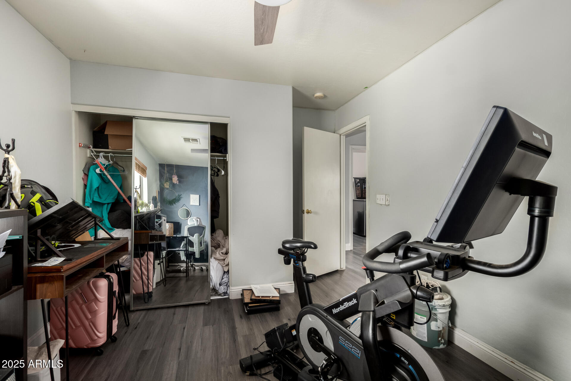 9415 West Eaton Road Phoenix, AZ 85037 - Photo 33 of 36 a room with gym equipment and wooden floor