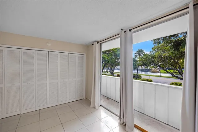 a view of a room with floor to ceiling windows and yard