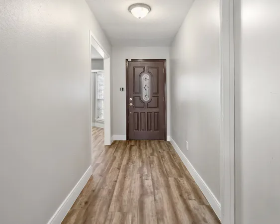 a view of a room with wooden floor