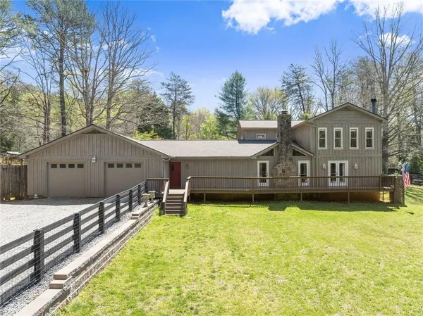 a front view of a house with garden yard and deck