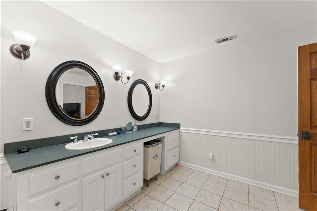 290 Chastain Road Sautee Nacoochee, GA 30571 - Photo 23 of 69 a bathroom with a granite countertop double vanity sink and a mirror
