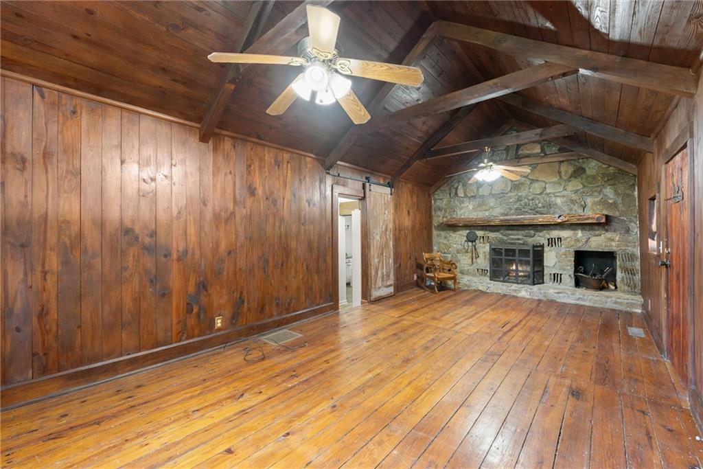 290 Chastain Road Sautee Nacoochee, GA 30571 - Photo 25 of 69 a view of an empty room with wooden floor fireplace and a window