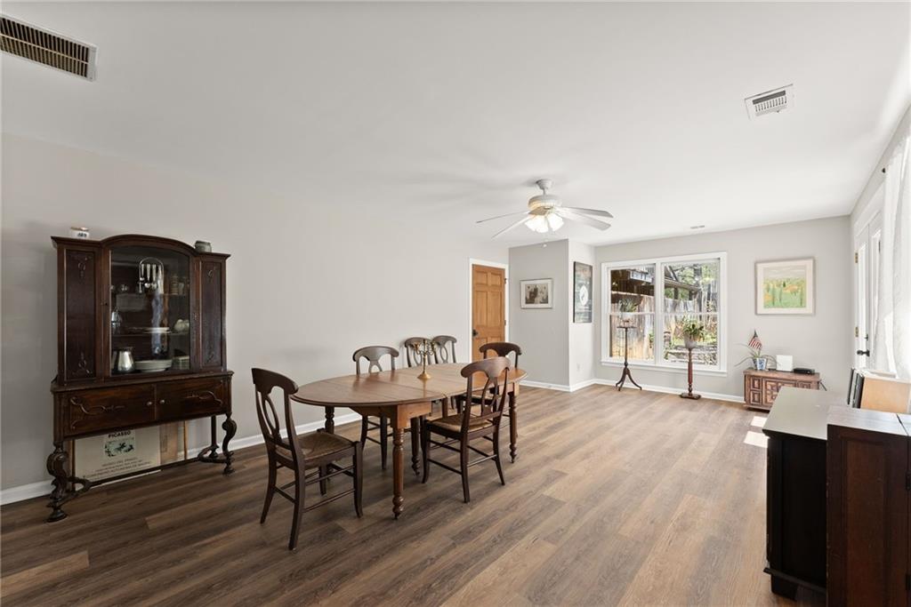 290 Chastain Road Sautee Nacoochee, GA 30571 - Photo 10 of 69 a dining room with wooden floor a chandelier a wooden table and chairs