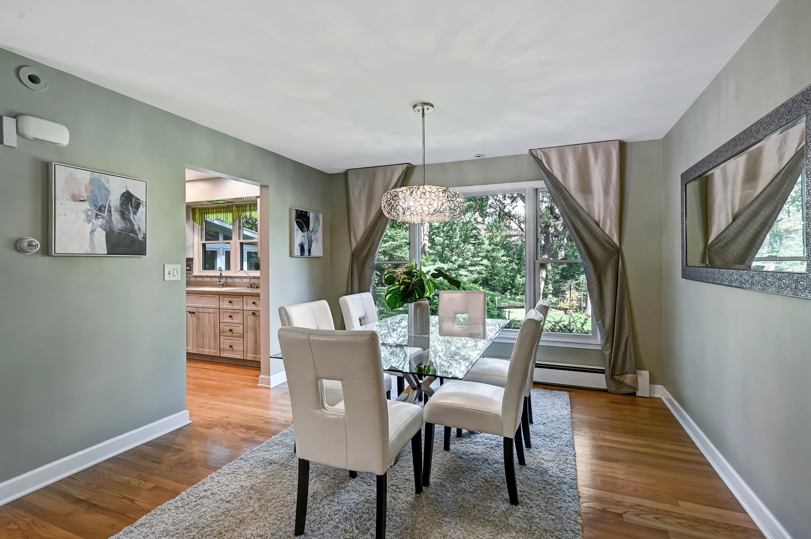 1200 Oak Hill Road Downers Grove, IL 60515 - Photo 4 of 24 a dining room with furniture a chandelier and wooden floor