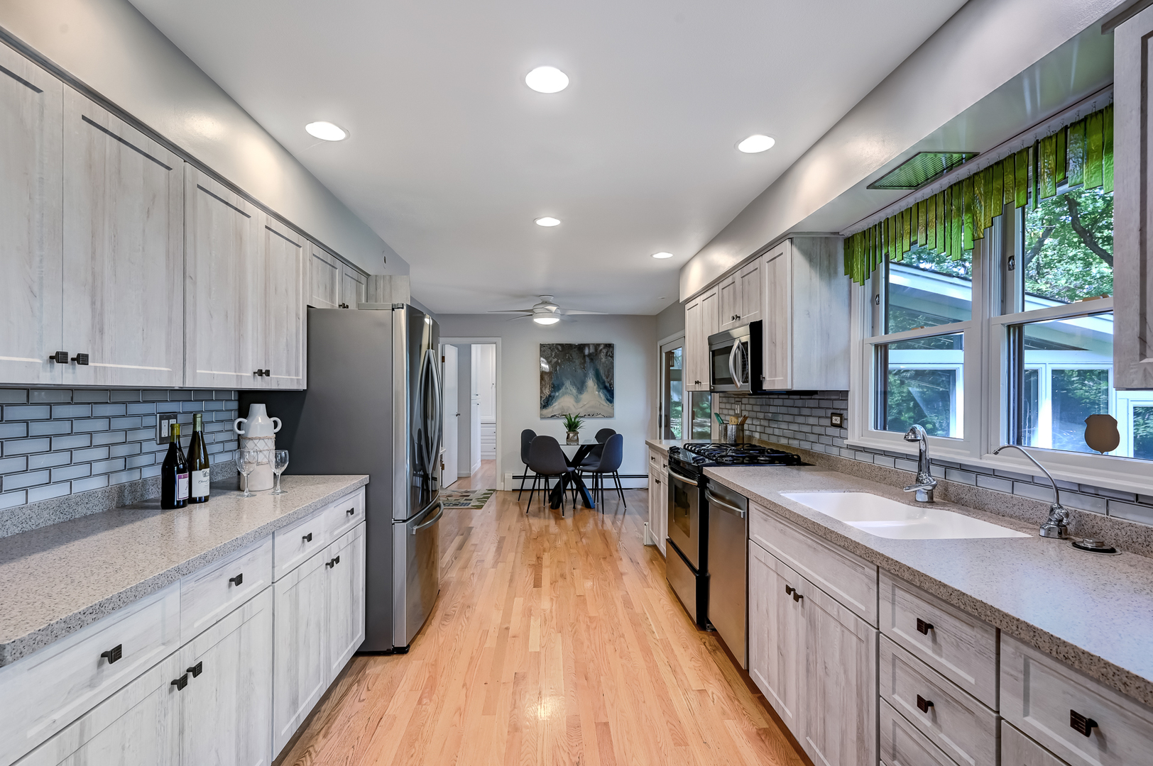 1200 Oak Hill Road Downers Grove, IL 60515 - Photo 6 of 24 a kitchen with sink cabinets and living room
