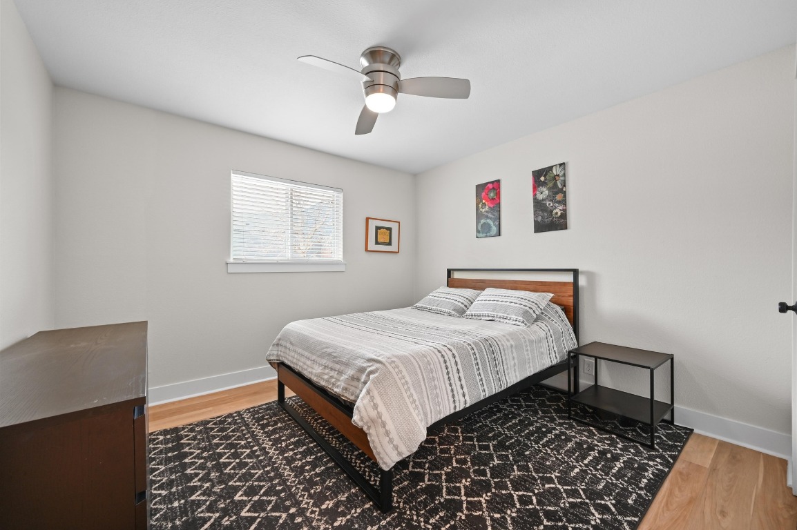 1307 Falcon Cove, Unit A Austin, TX 78745 - Photo 16 of 21 Bedroom with light wood-style floors and ceiling fan