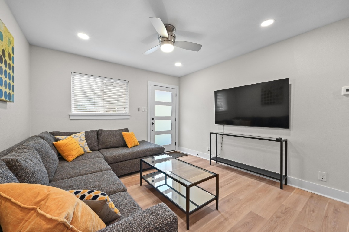 1307 Falcon Cove, Unit A Austin, TX 78745 - Photo 8 of 21 Living room with light wood-style floors, ceiling fan, and recessed lighting