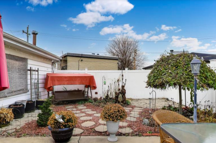 2643 Ridge Road Lansing, IL 60438 - Photo 29 of 30 a backyard of a house with barbeque oven table and chairs
