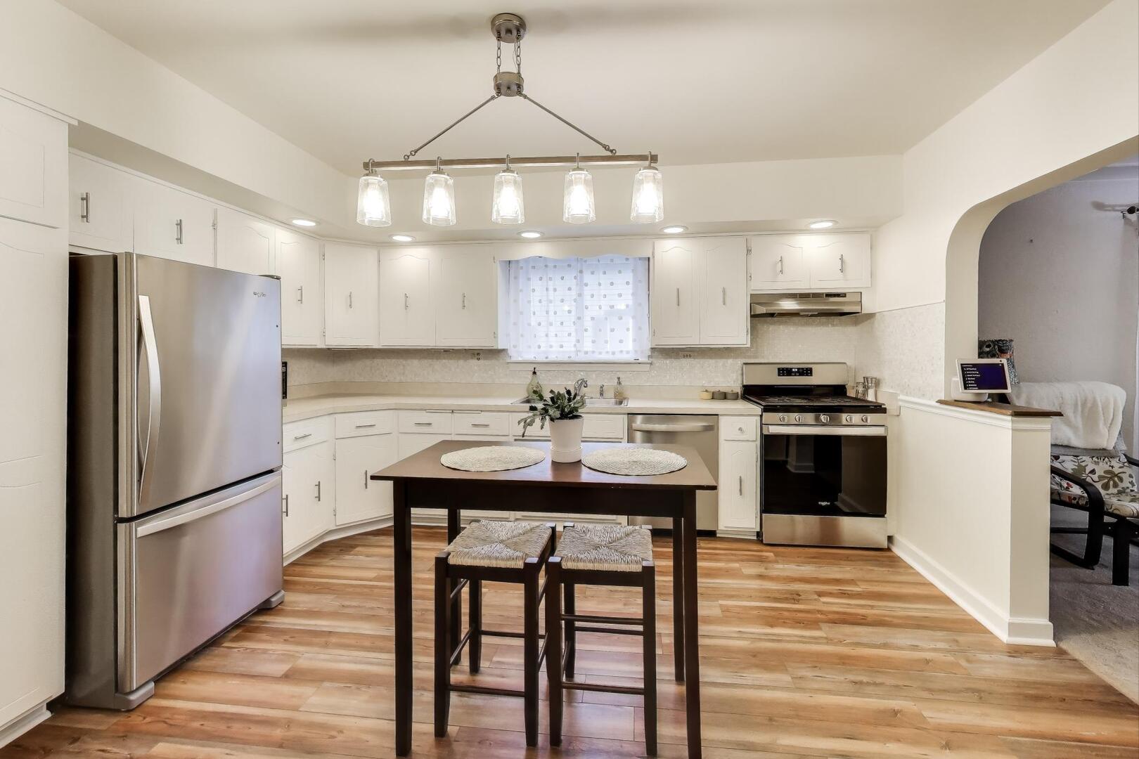 2643 Ridge Road Lansing, IL 60438 - Photo 7 of 30 a kitchen with granite countertop a refrigerator a sink dishwasher a stove and a refrigerator with wooden floor