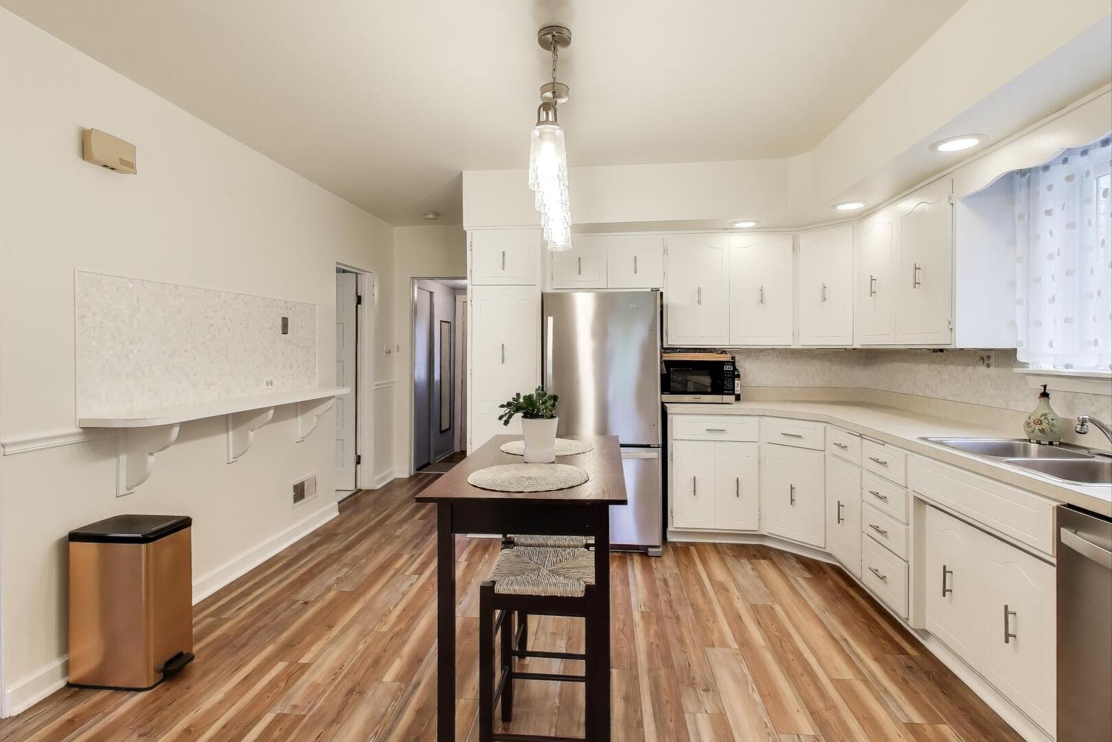 2643 Ridge Road Lansing, IL 60438 - Photo 8 of 30 a kitchen with refrigerator cabinets and wooden floor