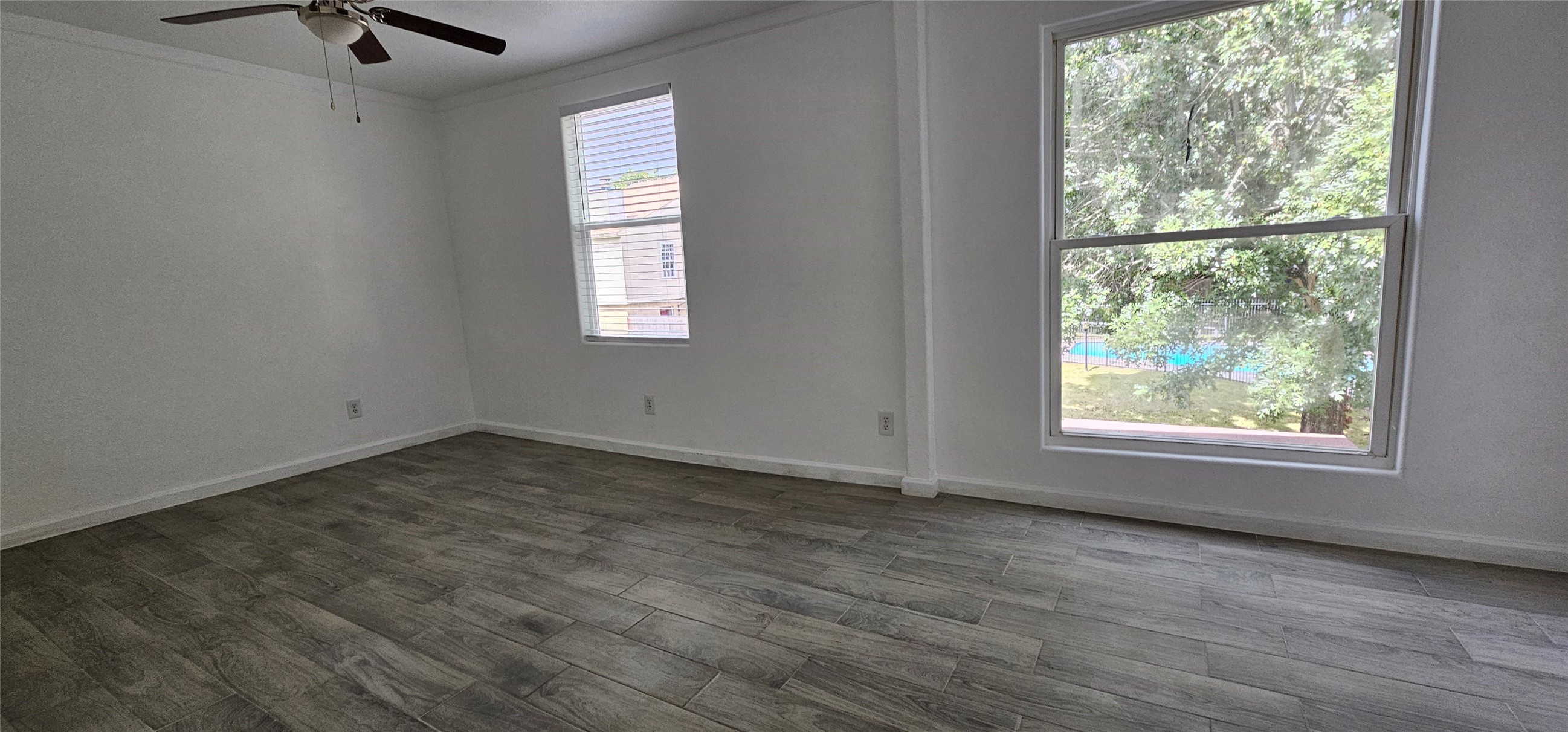 811 Knights Bridge Lane, Unit A Webster, TX 77058 - Photo 7 of 11 an empty room with wooden floor and windows
