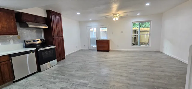 a kitchen with stainless steel appliances a refrigerator sink and stove