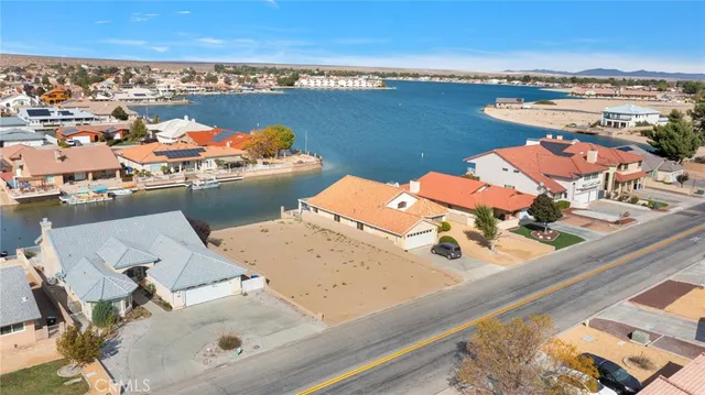 an aerial view of a house with outdoor seating