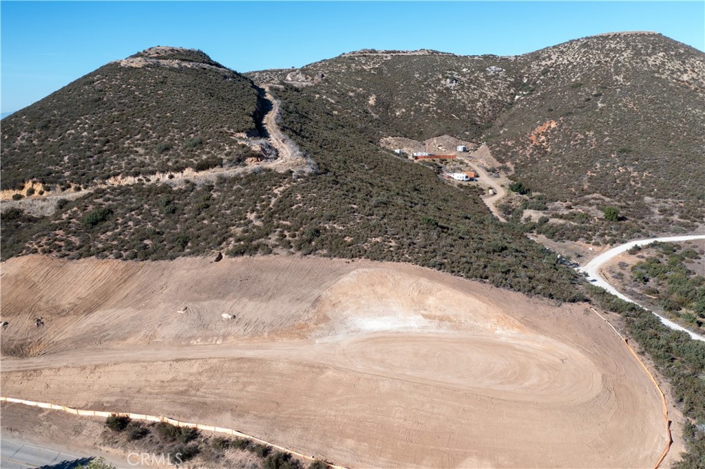 47066 Twin Pines Road Banning, CA 92220 - Photo 19 of 19 a view of a dry yard with mountains in the background
