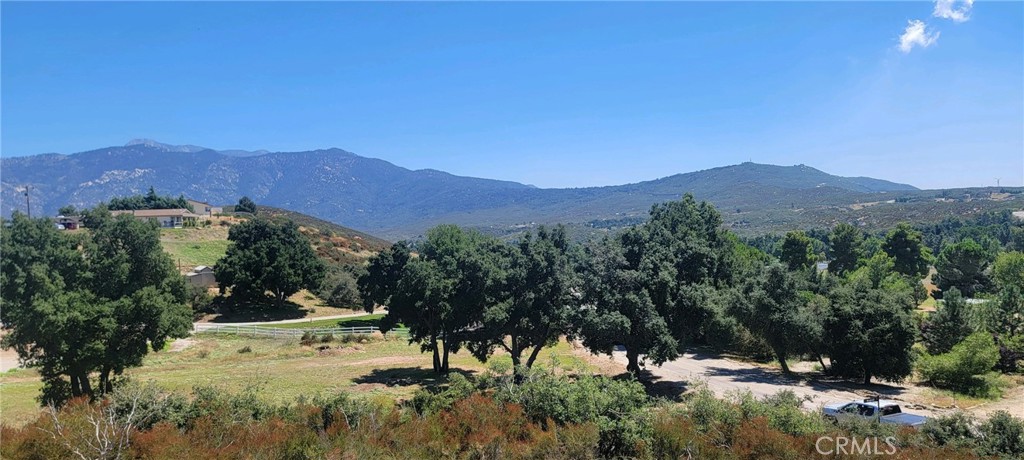 47066 Twin Pines Road Banning, CA 92220 - Photo 8 of 19 a view of a lush green hillside and houses
