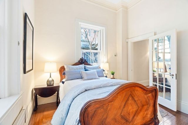 a bedroom with bed and wooden floor