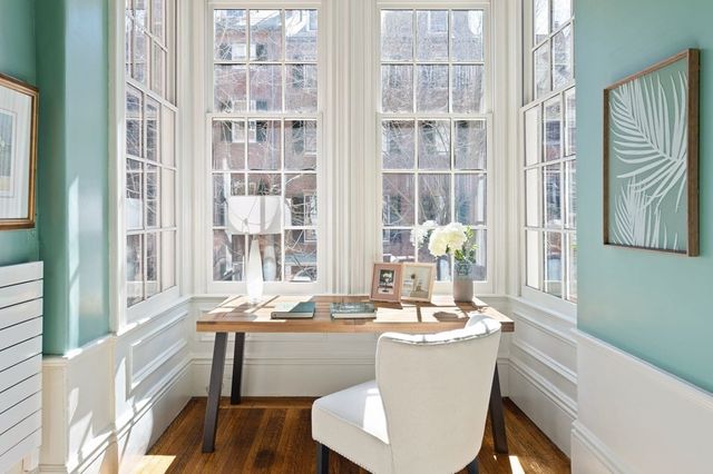 a room with a large window and chairs