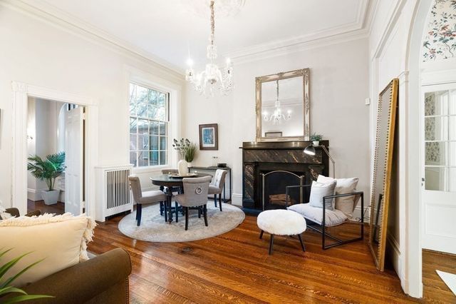 a view of a livingroom with furniture window and wooden floor