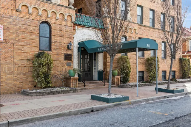 a view of a brick building with large windows