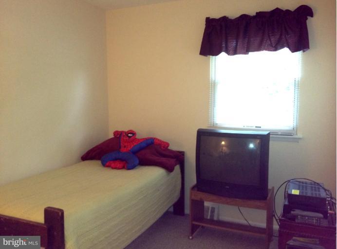 306 Bryanstone Road Reisterstown, MD 21136 - Photo 14 of 21 a bedroom with a bed a lamp and a window