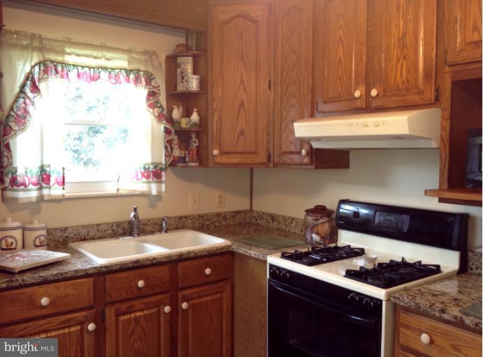 306 Bryanstone Road Reisterstown, MD 21136 - Photo 6 of 21 a kitchen with stainless steel appliances granite countertop a sink stove and cabinets