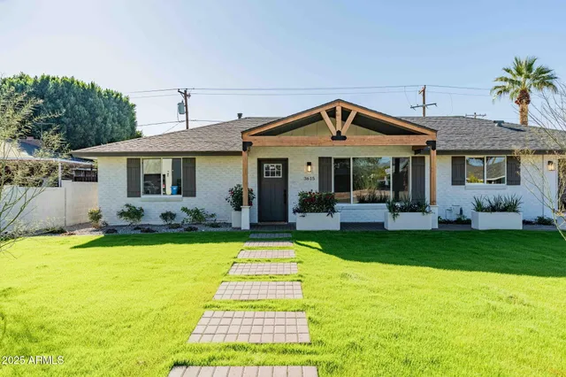 a front view of a house with swimming pool having outdoor seating