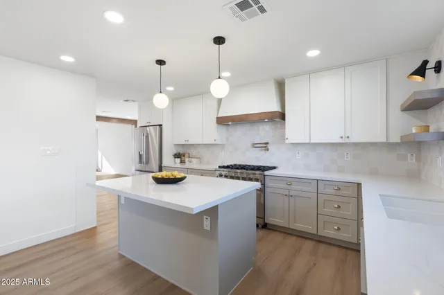 a hallway with wooden floor chandelier