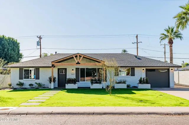 a front view of a house with a garden