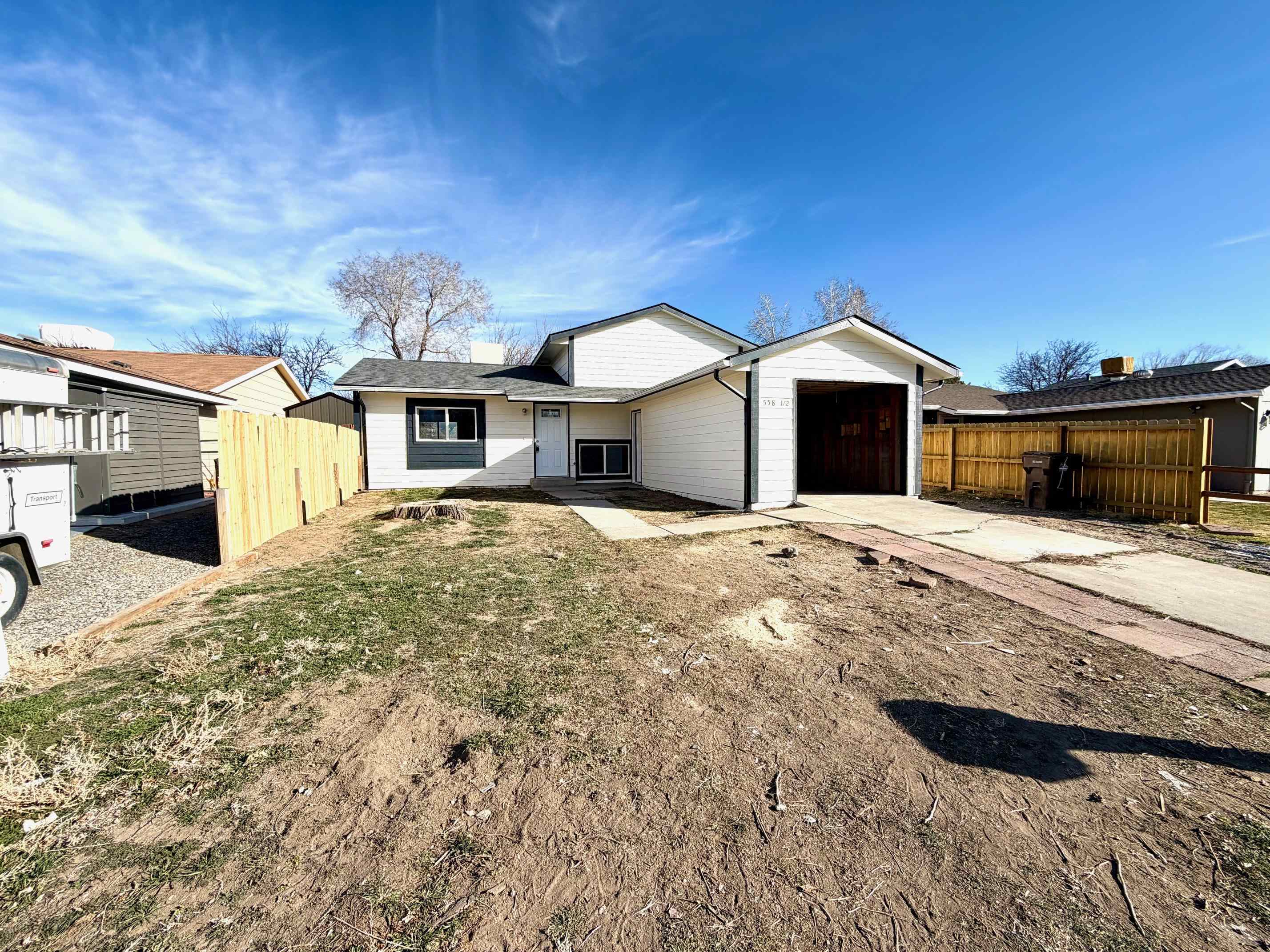 558 1/2 31 3/4 Road Grand Junction, CO 81504 - Photo 1 of 25 a front view of a house with a yard and garage