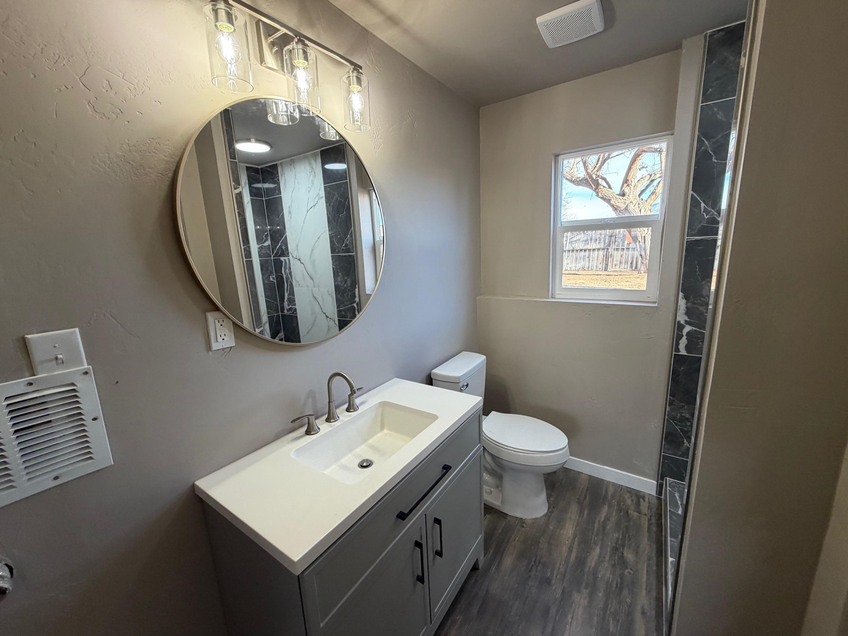 558 1/2 31 3/4 Road Grand Junction, CO 81504 - Photo 11 of 25 a bathroom with a toilet sink and mirror
