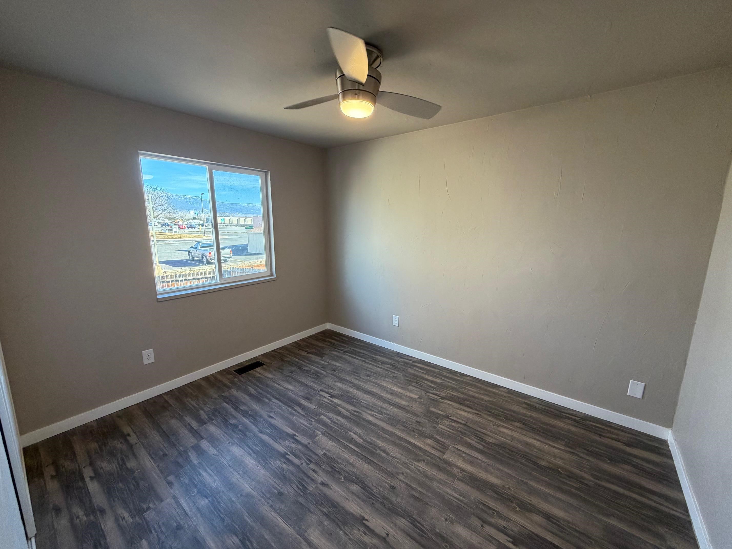 558 1/2 31 3/4 Road Grand Junction, CO 81504 - Photo 14 of 25 a view of an empty room with wooden floor and a window