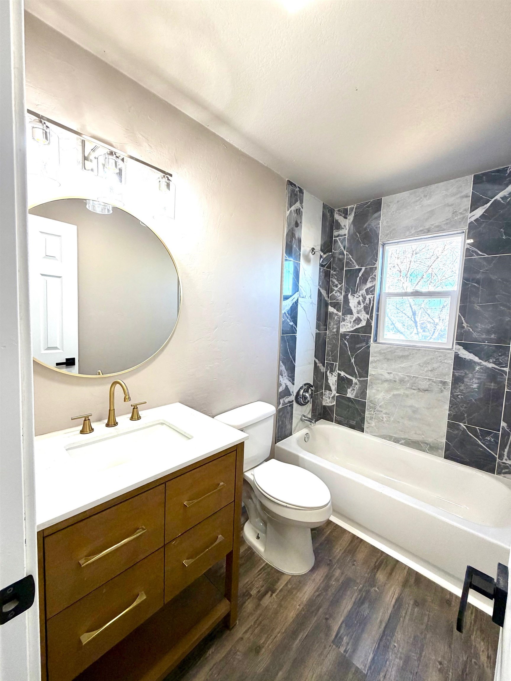 558 1/2 31 3/4 Road Grand Junction, CO 81504 - Photo 16 of 25 a bathroom with a double vanity sink toilet mirror and bathtub