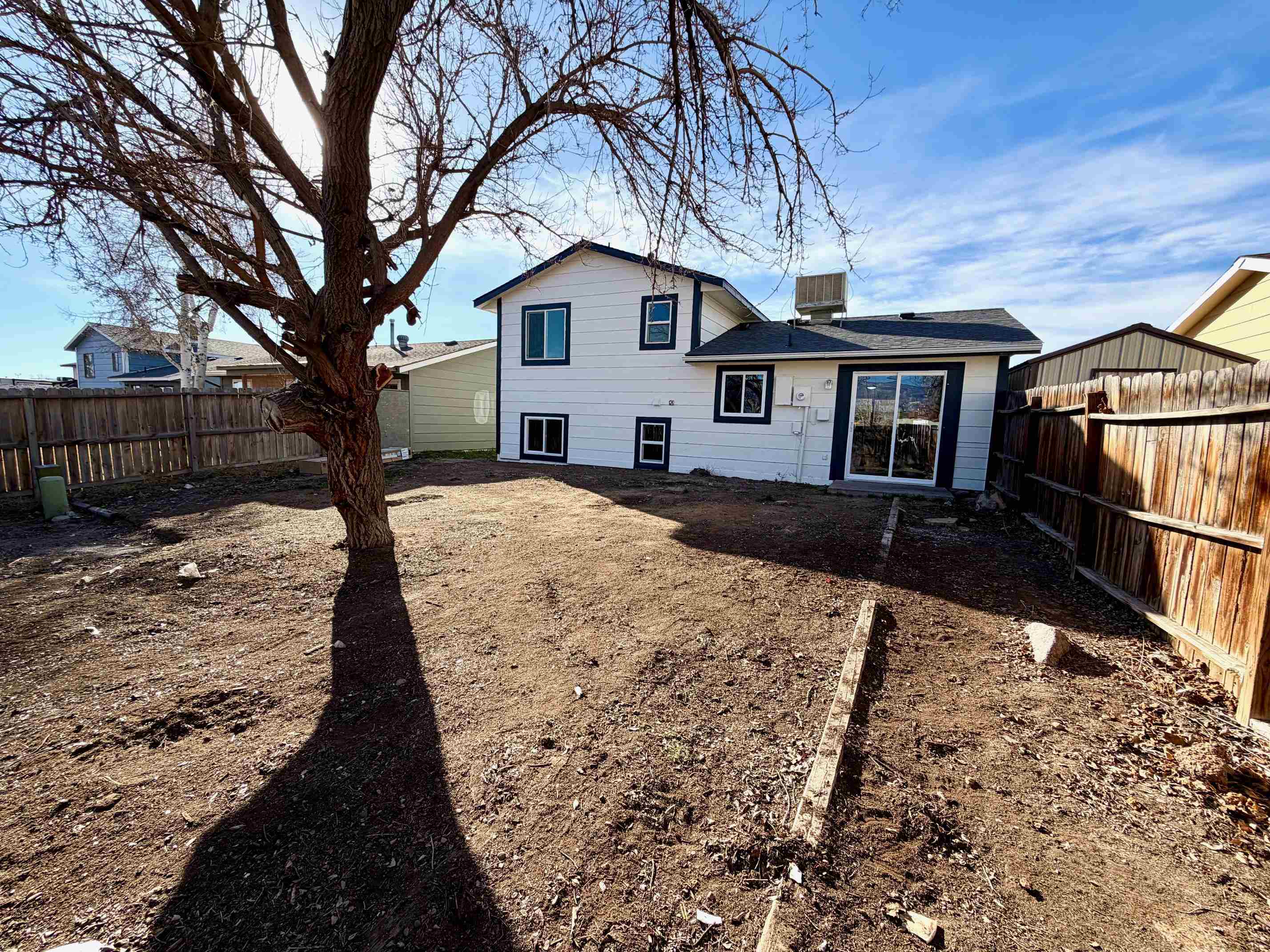558 1/2 31 3/4 Road Grand Junction, CO 81504 - Photo 23 of 25 a white house that has tree in front of it